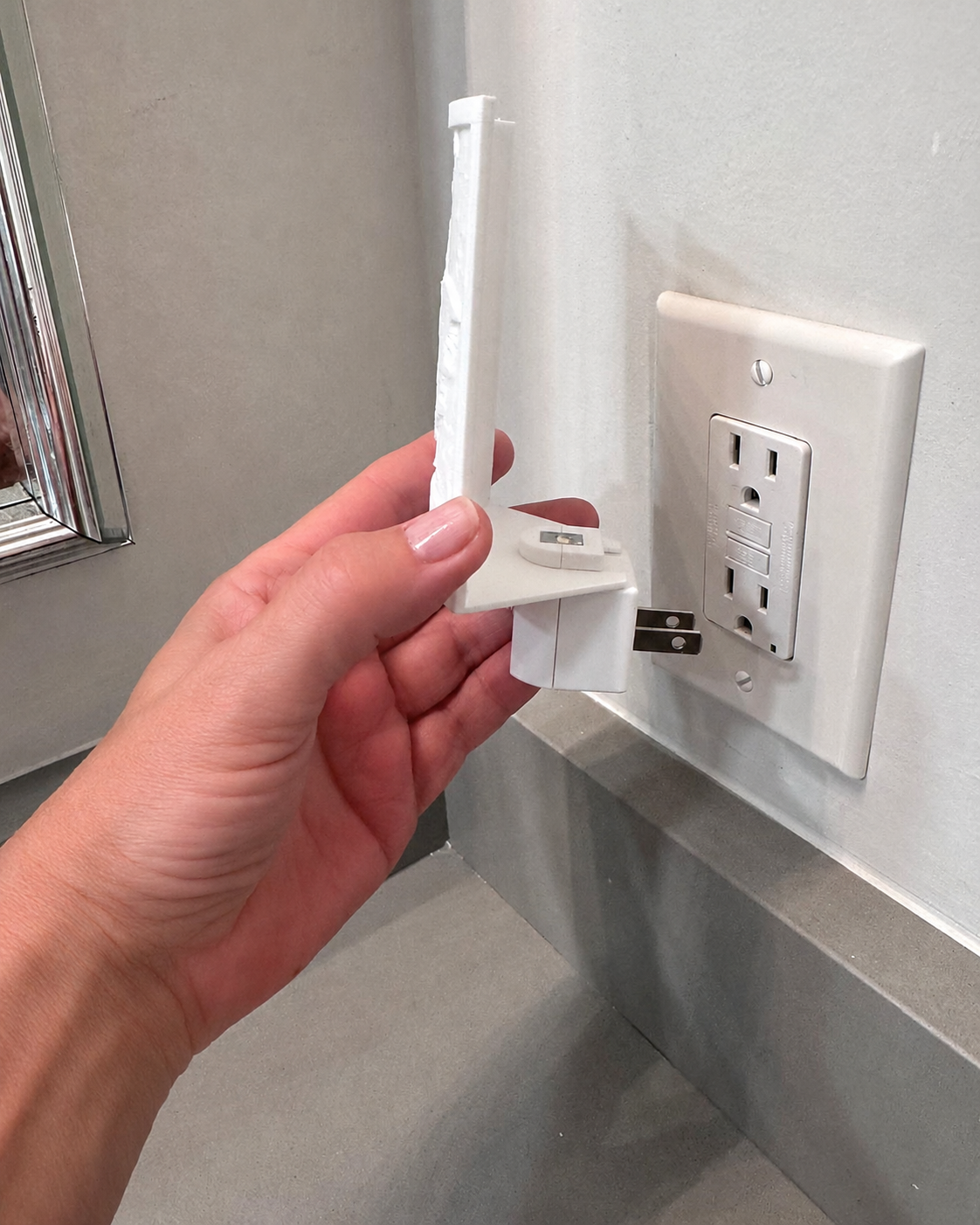 Night light base and lithophane shade being plugged into a wall outlet